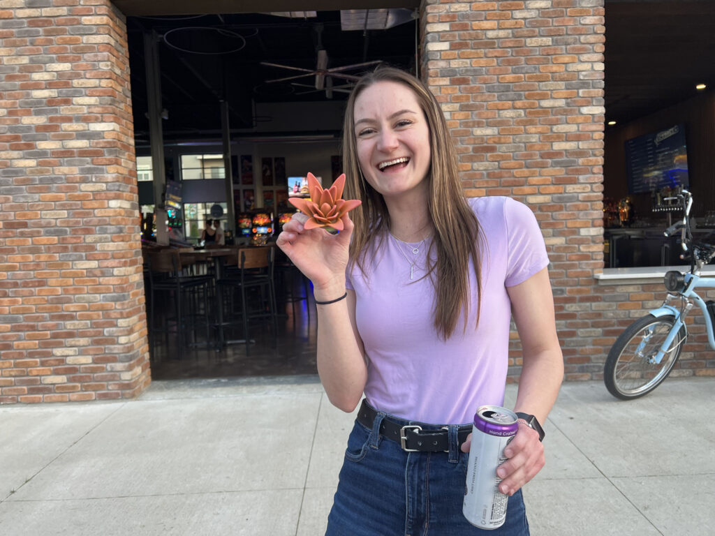 Belle holding a 3d printed flower