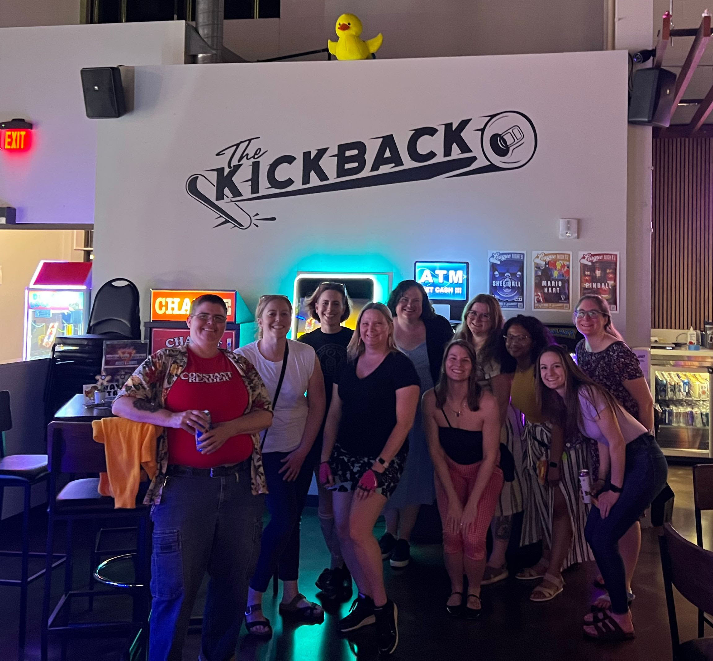 The group in front of the kickback sign