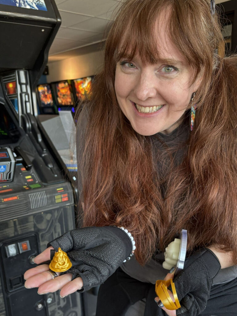 Dori holding a 3d printed poop emoji