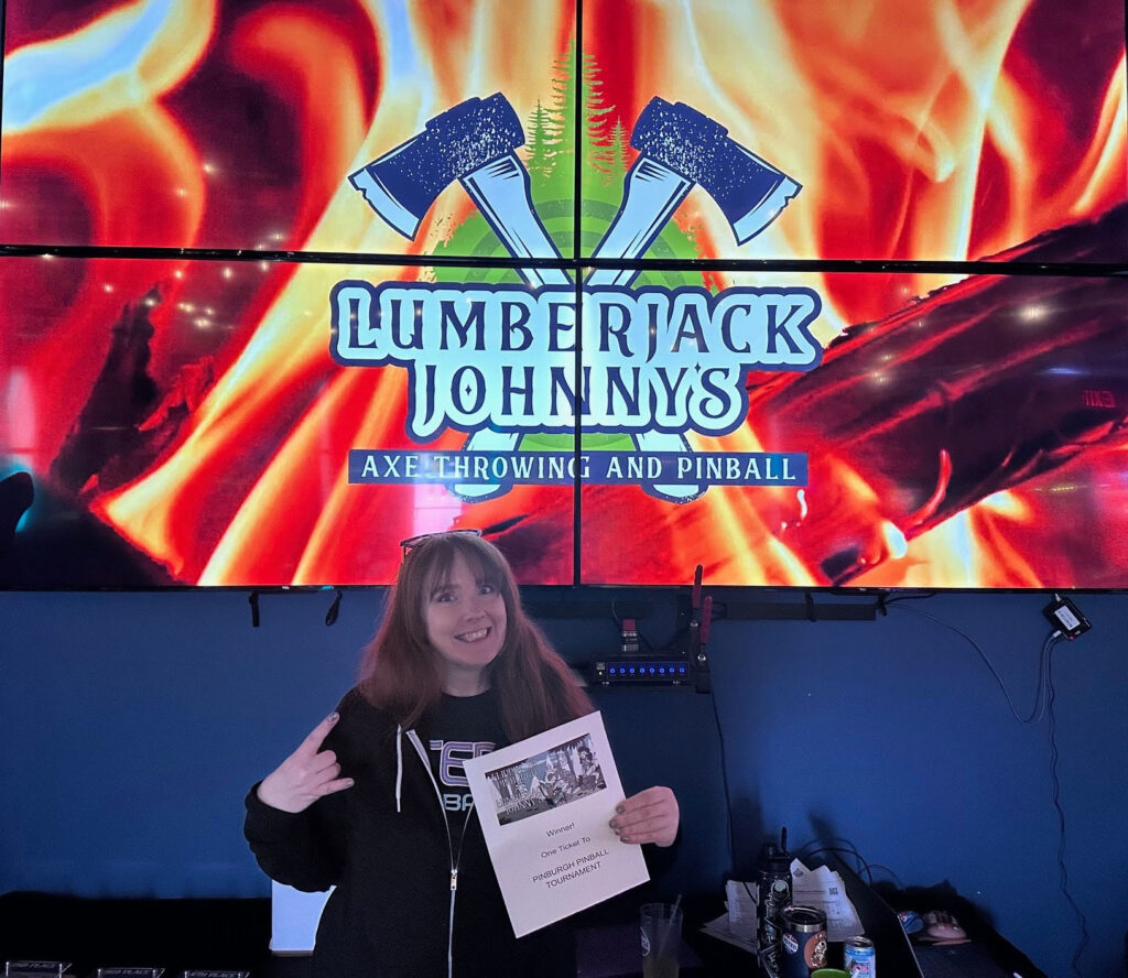 Dori holding her winnings at Jumberjack Johnny's