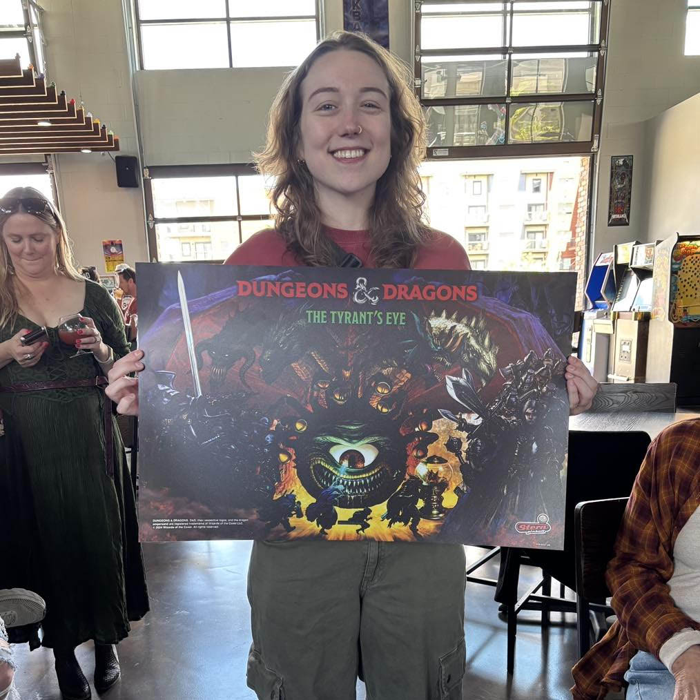Jill S holding Dungeons & Dragons the translite she won