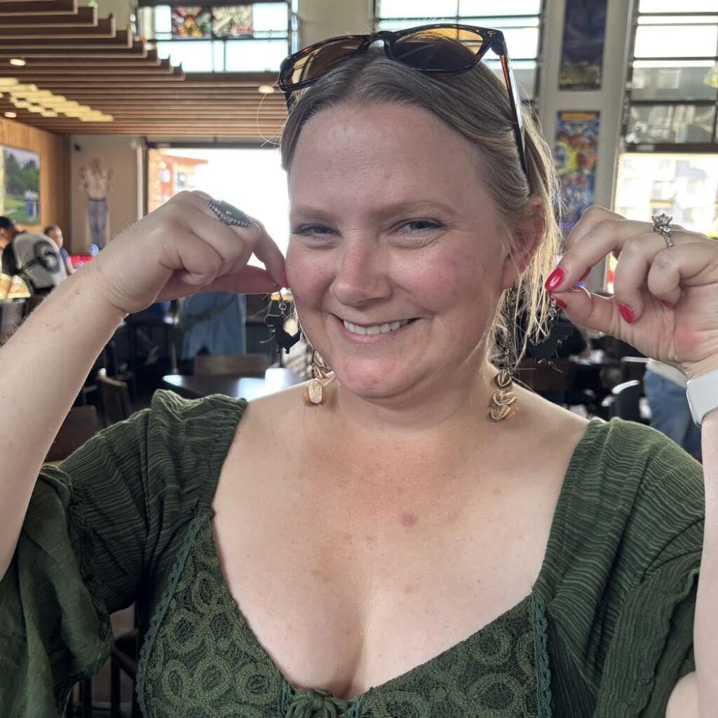 Donnelle holding the earrings she won