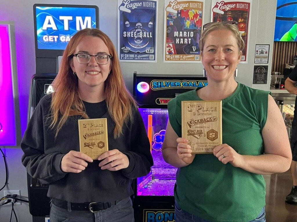 Lauren and Sara holding their plaques at the Kickback 9 finals