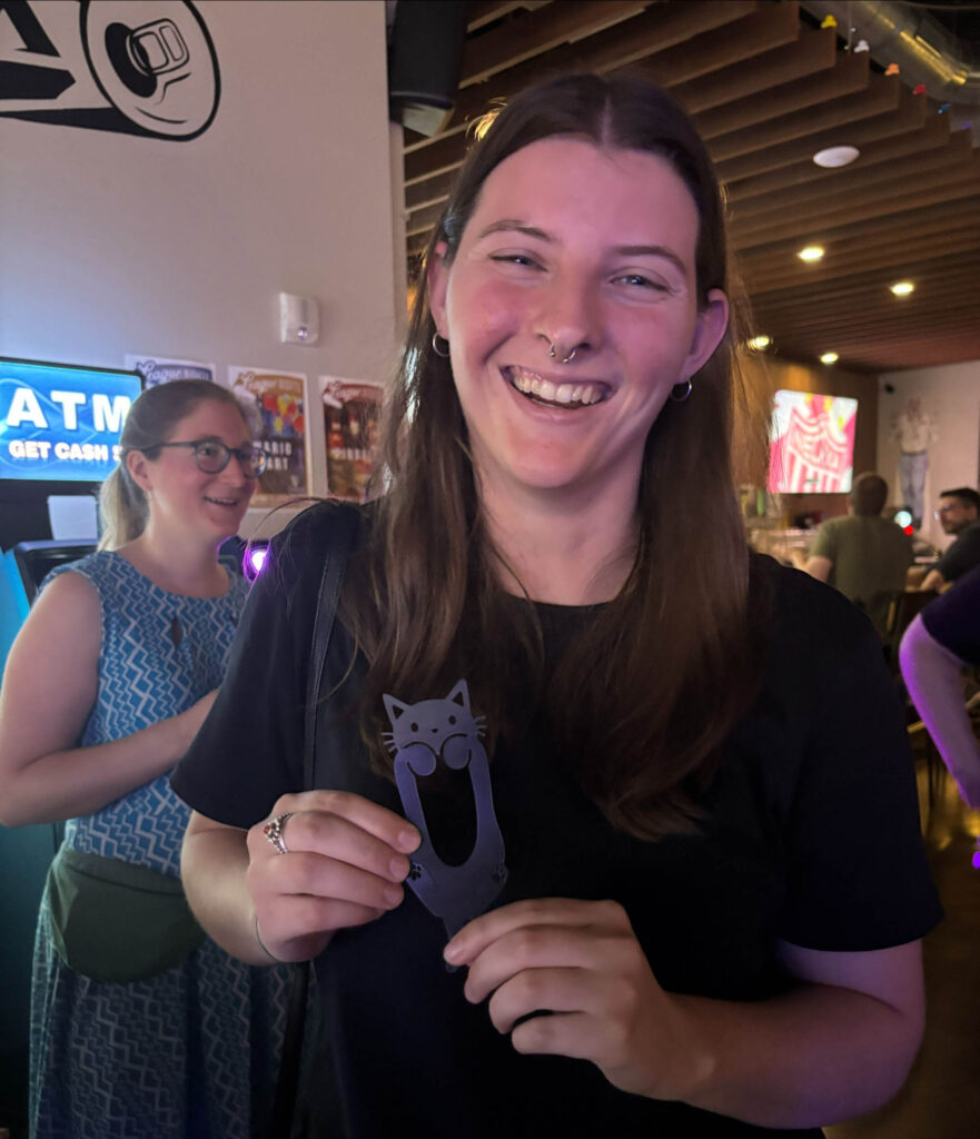 Jillian holding their winnings