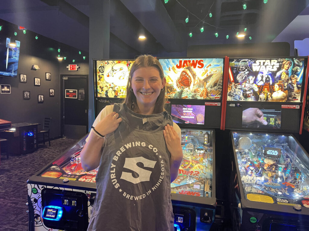 A winner holding up a surly brewing co shirt