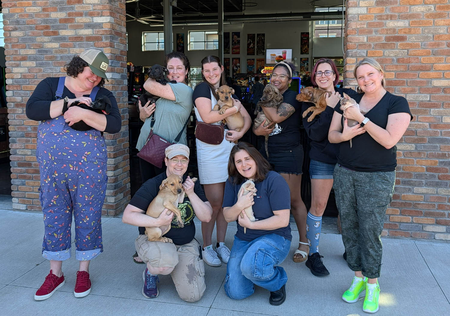 The group of belles at The Kickback all holding puppies!