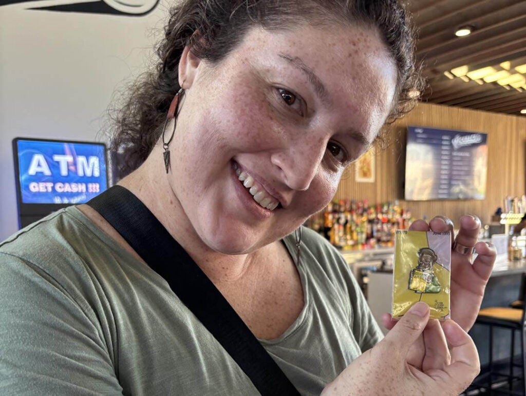 Dani holding a Simpsons enamel pin she just won