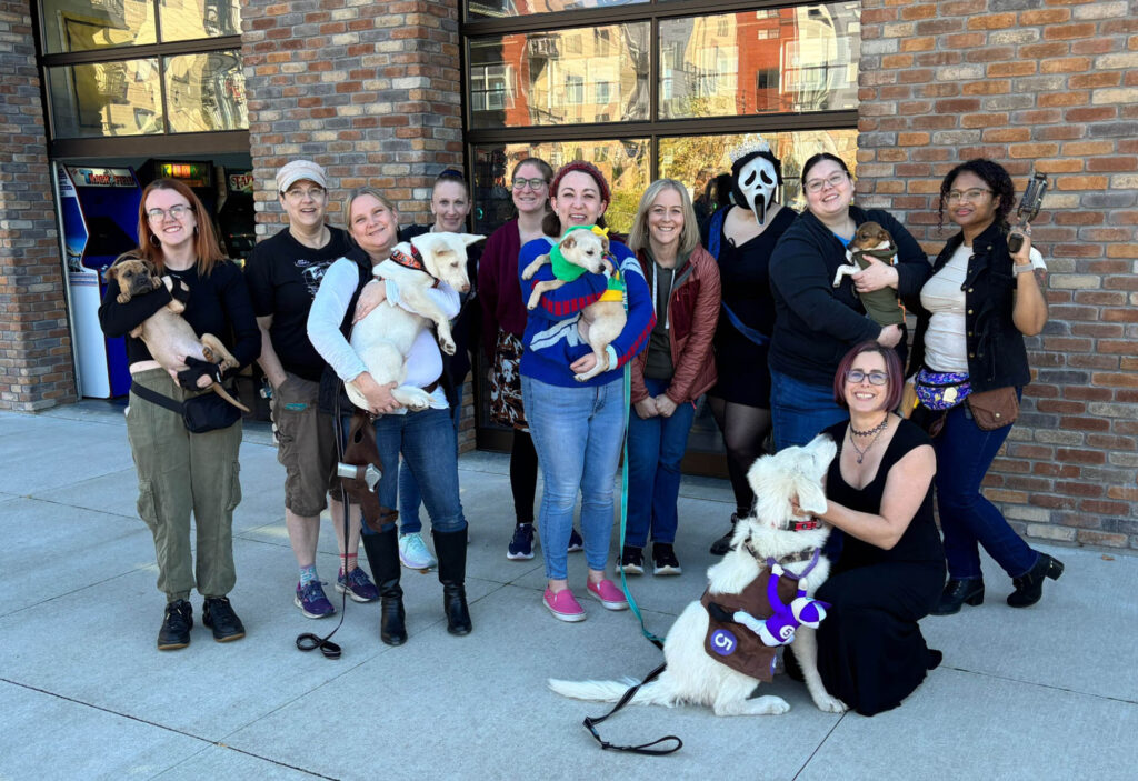 The group of players holding puppies at Kickback