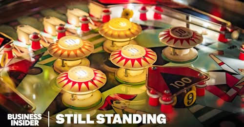 A old school pinball playfield with the words "Business Insider - Still Standing"