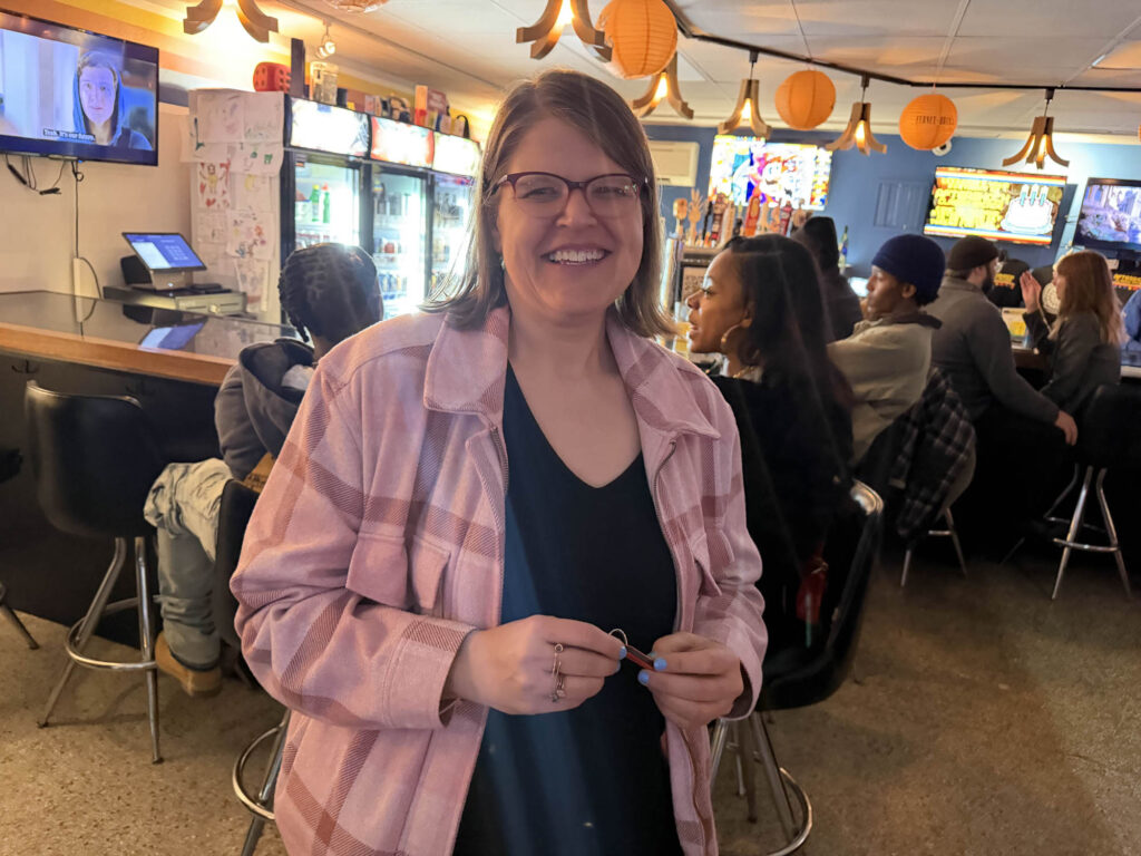 Liz holding her keychain she won