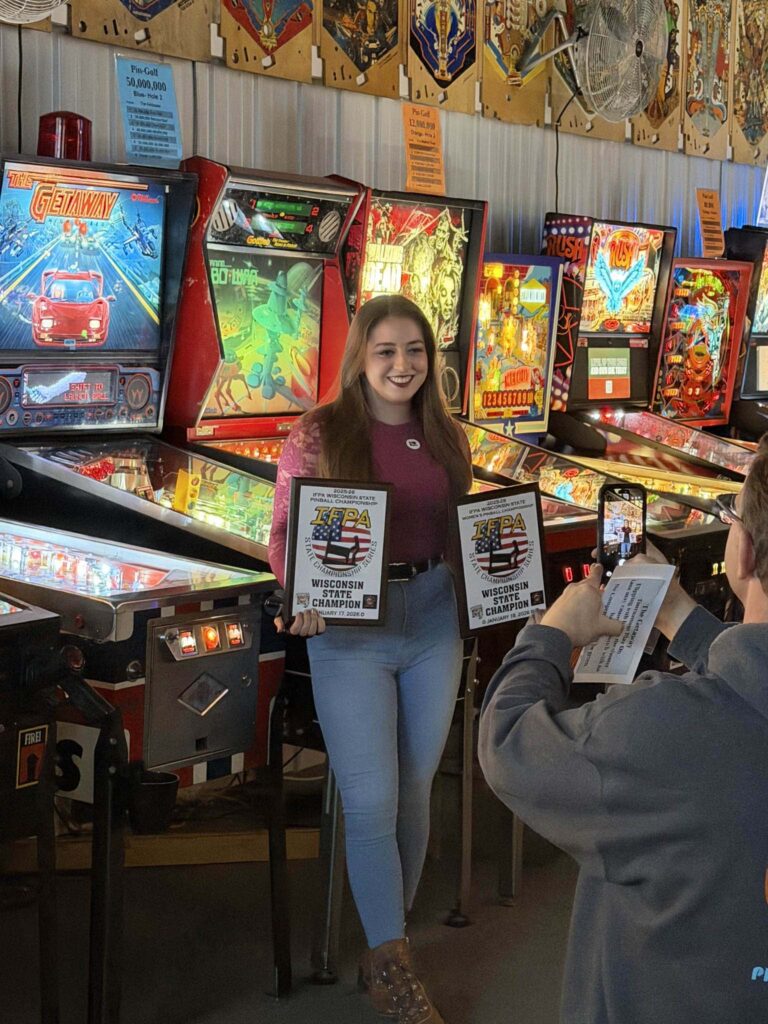 Kassidy holding both winning plaques from District 82 Women's State