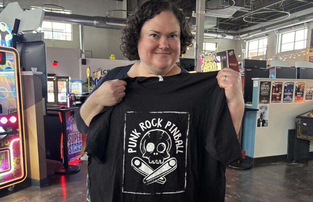 Tamara holding her new Punk Rock Pinball shirt