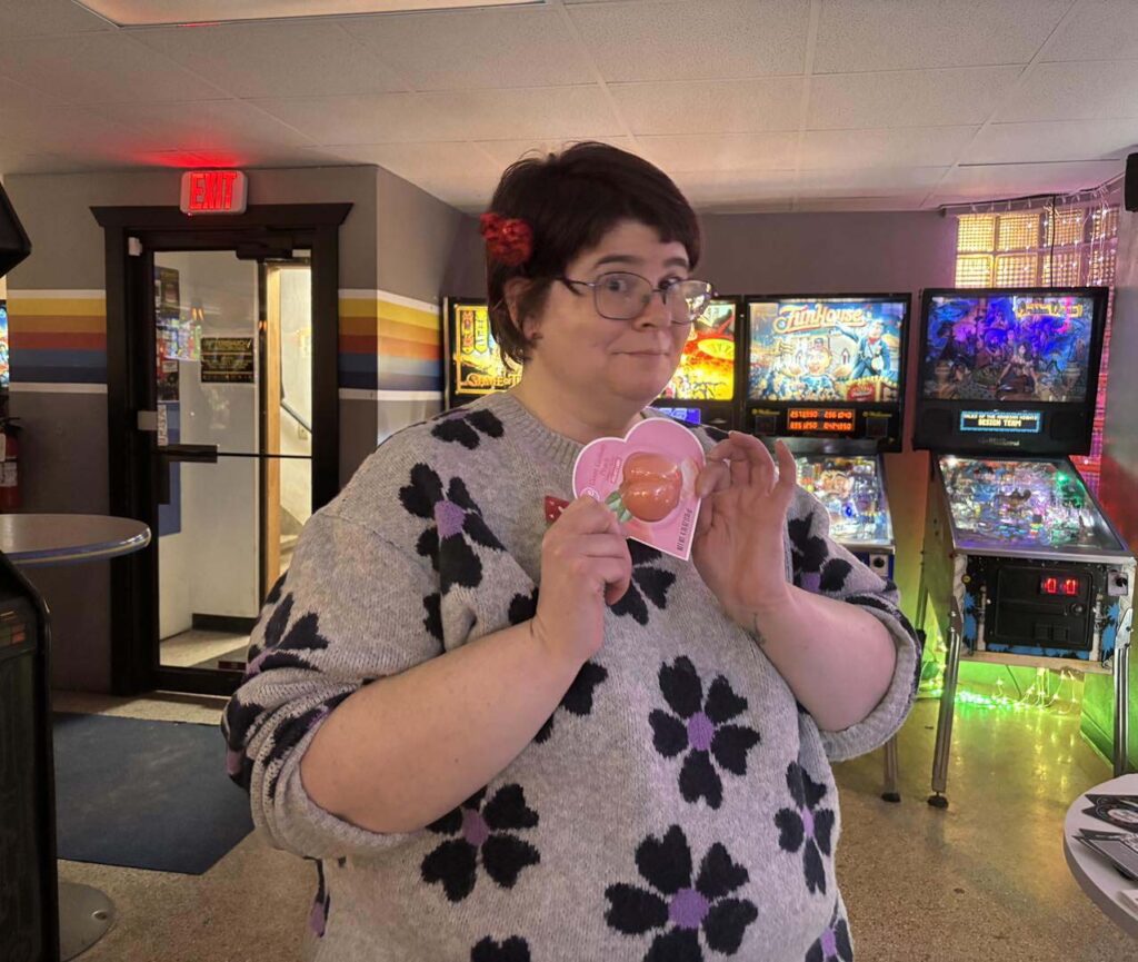 holding a butt shaped prize